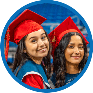 smiling students in graduation caps & gowns